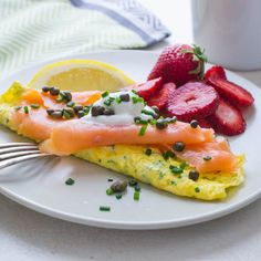 an omelet with salmon and strawberries on a plate