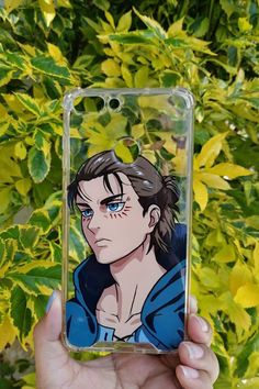 a person holding up a phone case with an anime character on it