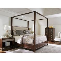 a four poster bed in a bedroom with white walls