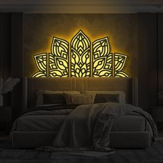 a large bed sitting in a bedroom next to a wall mounted light with an intricate design on it