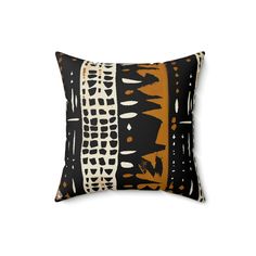 an orange and black pillow on a white background, with the image of abstract shapes