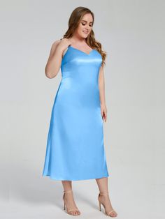 a woman in a blue dress posing for the camera