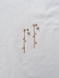 These earrings can be worn in 2 ways - as a backdrop with the long chain adorned with small freshwatwer pearls or just as a pearl droplets (you will recieve one extra back closure for secure wear) Made from genuine freshwater pearls and PVD gold plated stainless steel - tarnish resitant gold plating - you can wear your jewelry every day and it will remain gold (even when it comes in touch with water) Total lenght: 7 cm = 2.8" Can be made also in silver version (stainless steel) You will recieve White Pearl Drop Backdrop Necklace, Long Drop Pearl Bridal Earrings With Pearl Chain, Bridal Long Drop Pearl Earrings With Pearl Chain, Delicate Wedding Linear Earrings With Pearl Chain, Long Drop Pearl Earrings With Dangling Beads For Wedding, Wedding Long Drop Pearl Earrings With Dangling Beads, Long Drop Pearl Chain Bridal Earrings, Wedding Long Drop Pearl Chain Linear Earrings, Pearl Backdrop