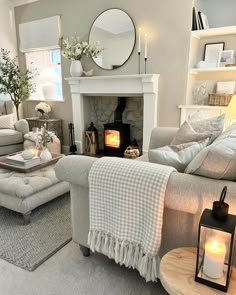 a living room filled with furniture and a fire place in the middle of the room