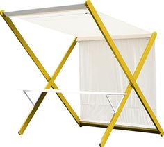 a yellow and white tent with two chairs on it's sides next to each other