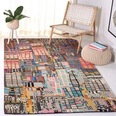 a multicolored area rug in a room with a chair and potted plant