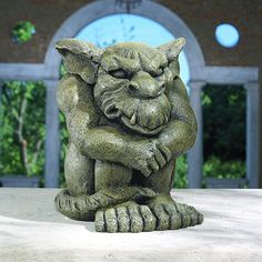 a statue of a cat sitting on top of a table