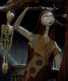 a woman with red hair standing next to a skeleton