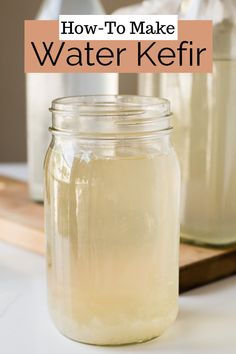 two jars filled with water sitting on top of a counter next to a cutting board