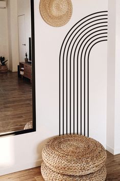 a basket sitting on top of a wooden floor next to a wall with a mirror