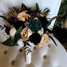 a bouquet of flowers sitting on top of a white chair