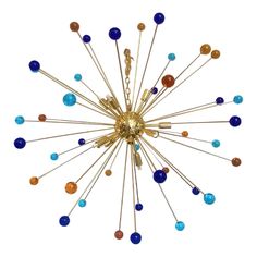 a gold chandelier with blue, orange and yellow glass beads on it's sides