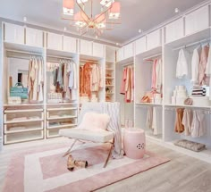 a white closet filled with lots of pink and white items on top of carpeted flooring