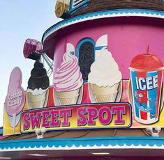 an ice cream shop sign on the side of a building with lots of different flavors