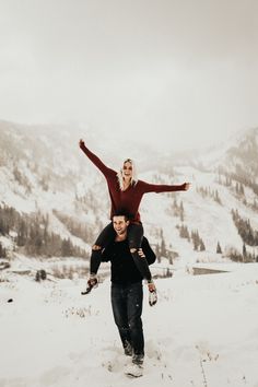 a man carrying a woman on his back in the snow