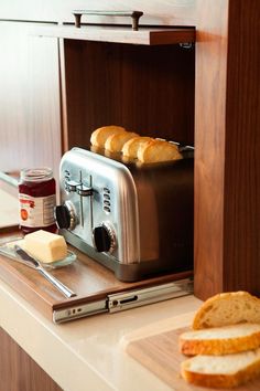 a toaster sitting on top of a counter next to sliced bread