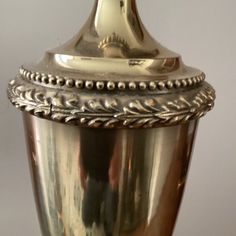 an ornate silver urn with a gold top