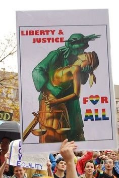 a protester holds up a sign with an image of liberty and justice