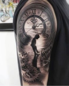 a man with a clock tattoo on his arm is standing in water and holding a fishing rod