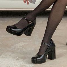 a woman wearing black high heels and stockings