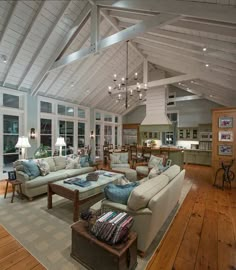 a living room filled with furniture and lots of windows