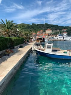 a small boat is docked at the dock