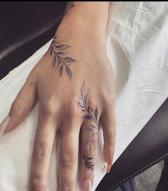 a woman's hand with tattoos on it