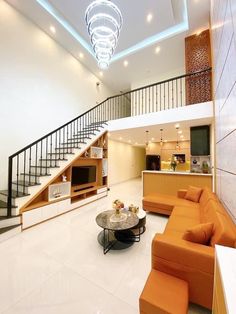 a living room filled with furniture and a stair case