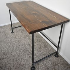 a wooden table sitting on top of a metal frame