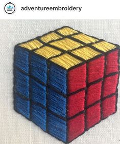 an image of a rubik cube made out of colored yarn on a white background