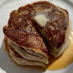 pancakes with butter and syrup on a white plate