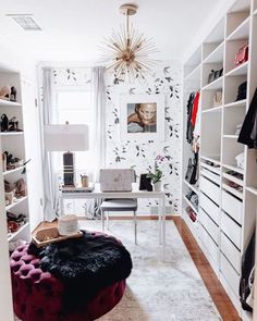 a room with white walls and shelves filled with clothes, shoes and other items in it