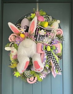 a wreath with an easter bunny on the front door