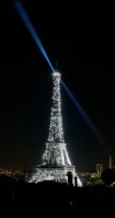 the eiffel tower is lit up at night