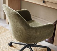 a green chair sitting on top of a wooden desk