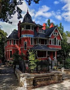 a large red house sitting on the side of a road