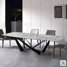 a marble dining table and chairs in a room with white walls, carpeted flooring and artwork on the wall