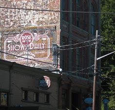 an old brick building with a sign for the show daily on it's side