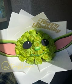 a close up of a birthday card with flowers on it and a face made out of paper