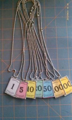 a necklace with four different numbers on it and a chain attached to it that says $ 1, 500