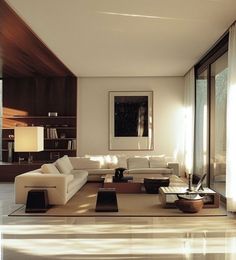 a modern living room with white furniture and large glass doors that open to the outdoors