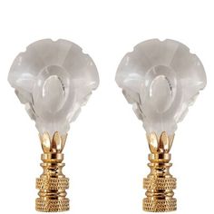 two white glass flowers on gold plated bases