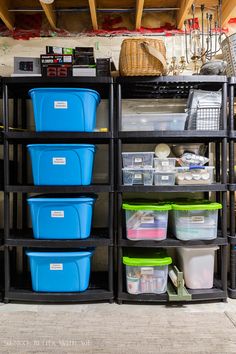 several plastic containers are stacked on top of each other in front of a storage rack