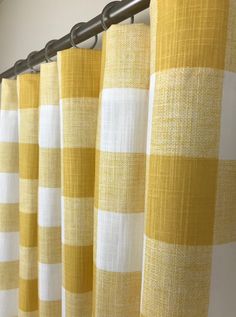 yellow and white checkered curtains hanging on a curtain rod