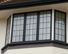 a black and white window on the side of a building with two windows in it