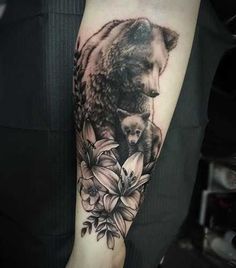 a bear and cub tattoo on the arm