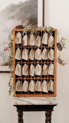 a wooden box filled with white shoes on top of a table next to a painting