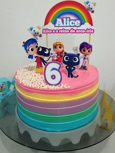 there is a birthday cake with cartoon characters on it and the number six in front