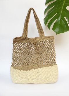 Stylish and on trend, this beautiful tote is handmade by artisans from Santander, Colombia. 100% made of Fique natural fiber, a plant similar to Agave, it is the perfect summer accessory to be used out in the city or to spend a day at the beach. With two easy to carry handles, you will want to carry it around everywhere you go!Approximate Dimensions:Height: 17" / 43 cmWidth: 16.1” / 41 cmStrap drop: 9"/ 23 cmAll of our bags are 100% handmade from natural fibers. Please allow for any color and si Natural Fiber Shoulder Bag For Vacation, Bohemian Natural Shoulder Bag With Double Handle, Eco-friendly Palm Leaf Bag With Open Weave, Eco-friendly Woven Beige Straw Bag, Natural Fiber Summer Shoulder Bag, Natural Summer Shoulder Bag In Natural Fiber, White Bohemian Natural Fiber Bag, Eco-friendly Natural Shoulder Bag For Vacation, Eco-friendly Shoulder Bag With Open Weave For Everyday Use