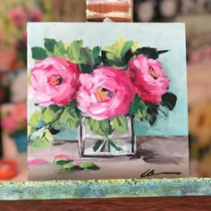 a painting of pink roses in a vase on a table with other flowers behind it